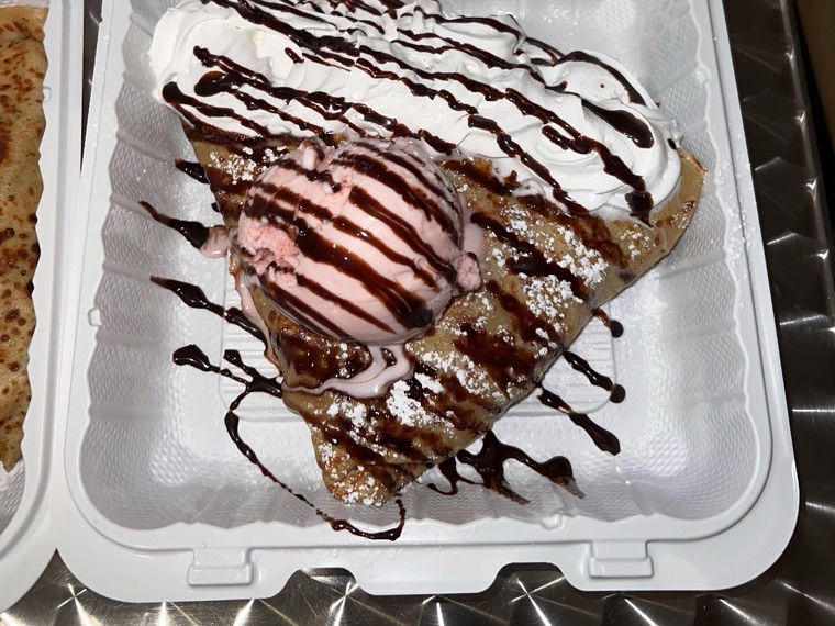 Photo from Riri Kingg's Google review — crepe with strawberry ice cream and chocolate drizzle